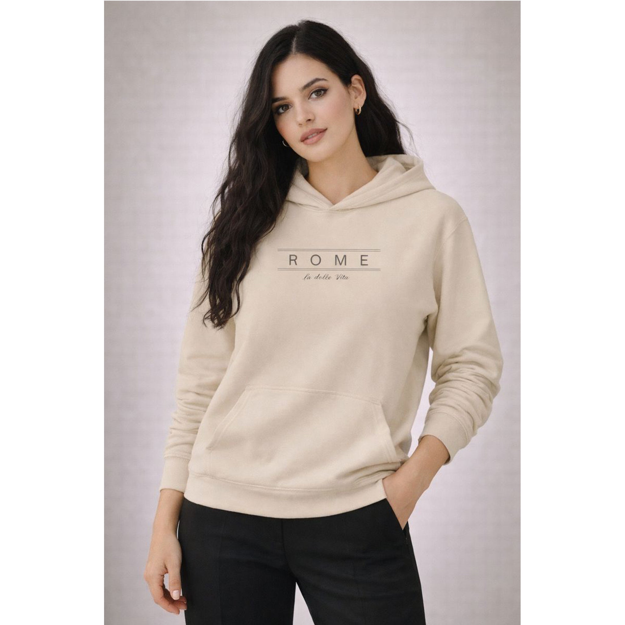 Woman wearing a beige hoodie with 'Rome' text on a plain background