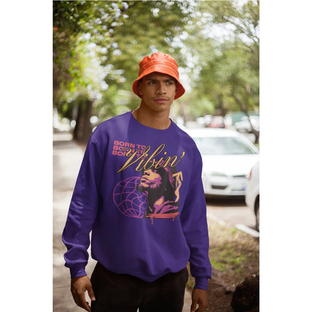 Person wearing a purple sweatshirt with graphic design outdoors