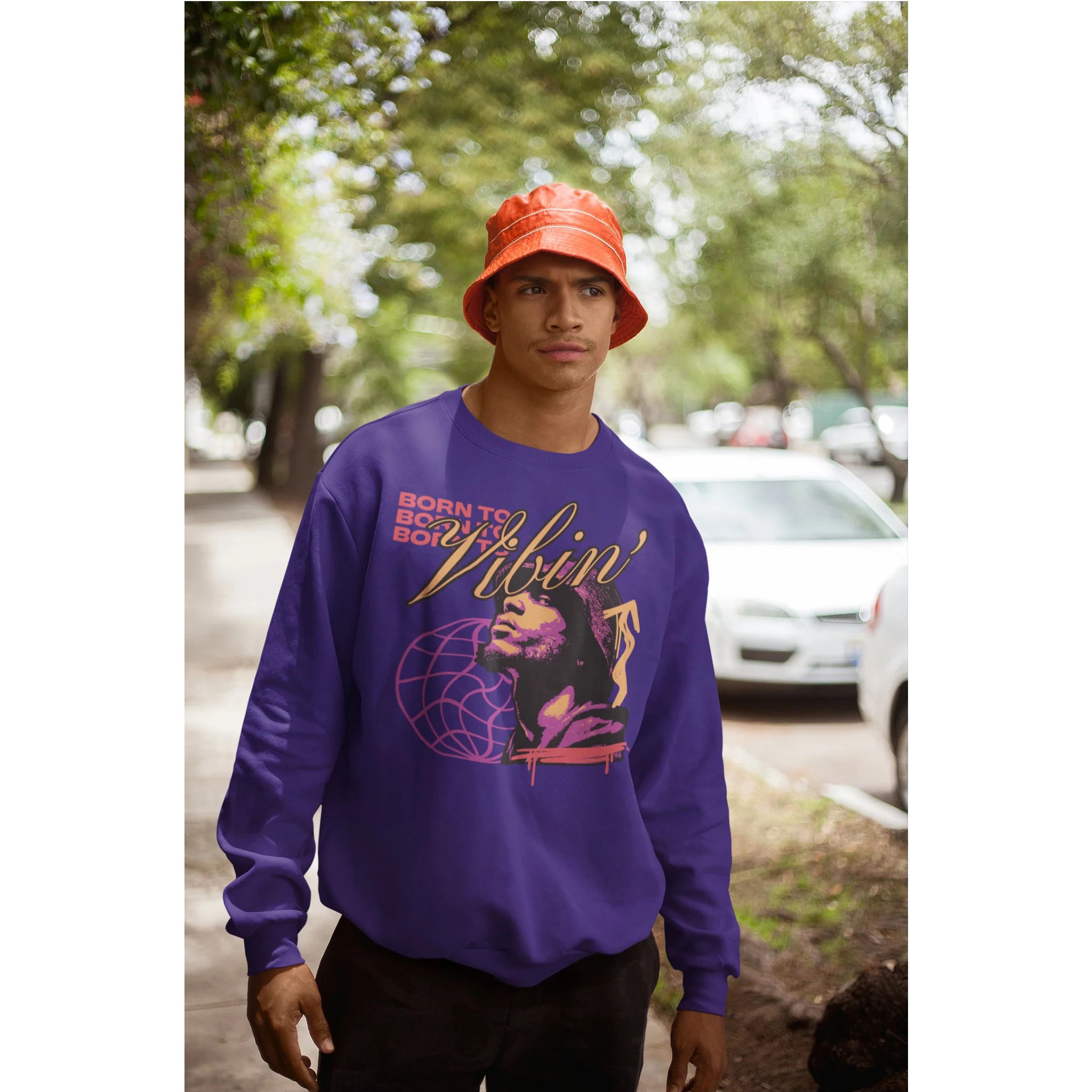 Person wearing a purple sweatshirt with graphic design outdoors