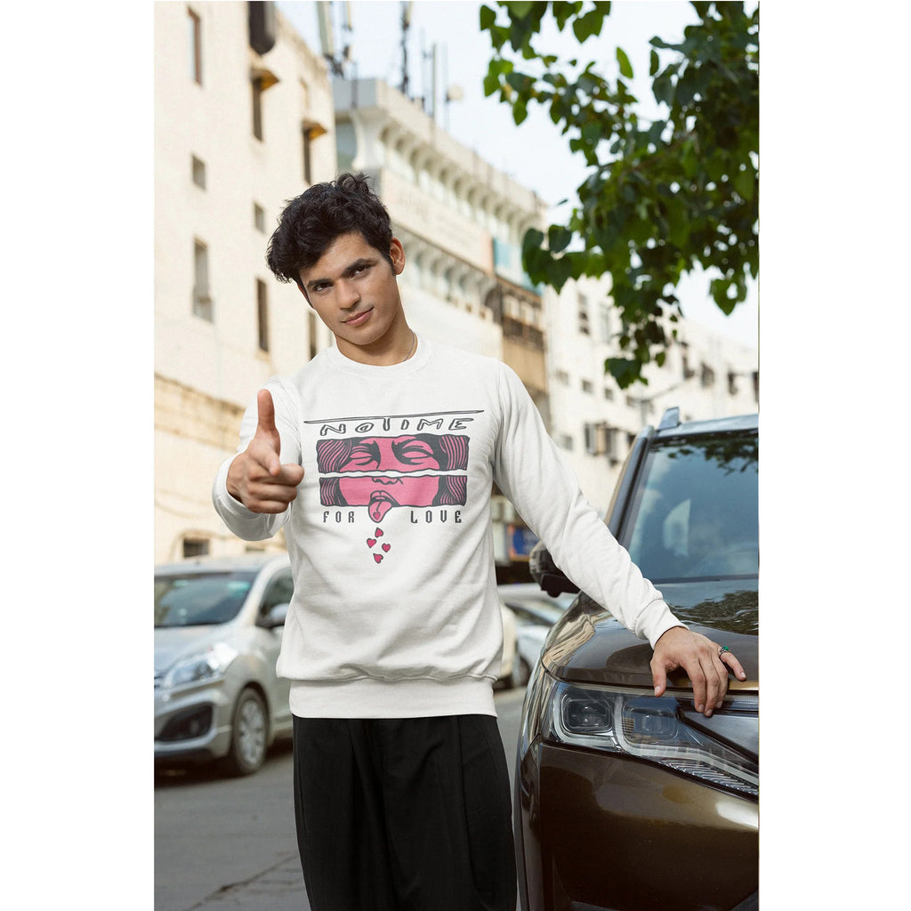 Person wearing a white sweatshirt with graphic design, standing next to a car on a city street.