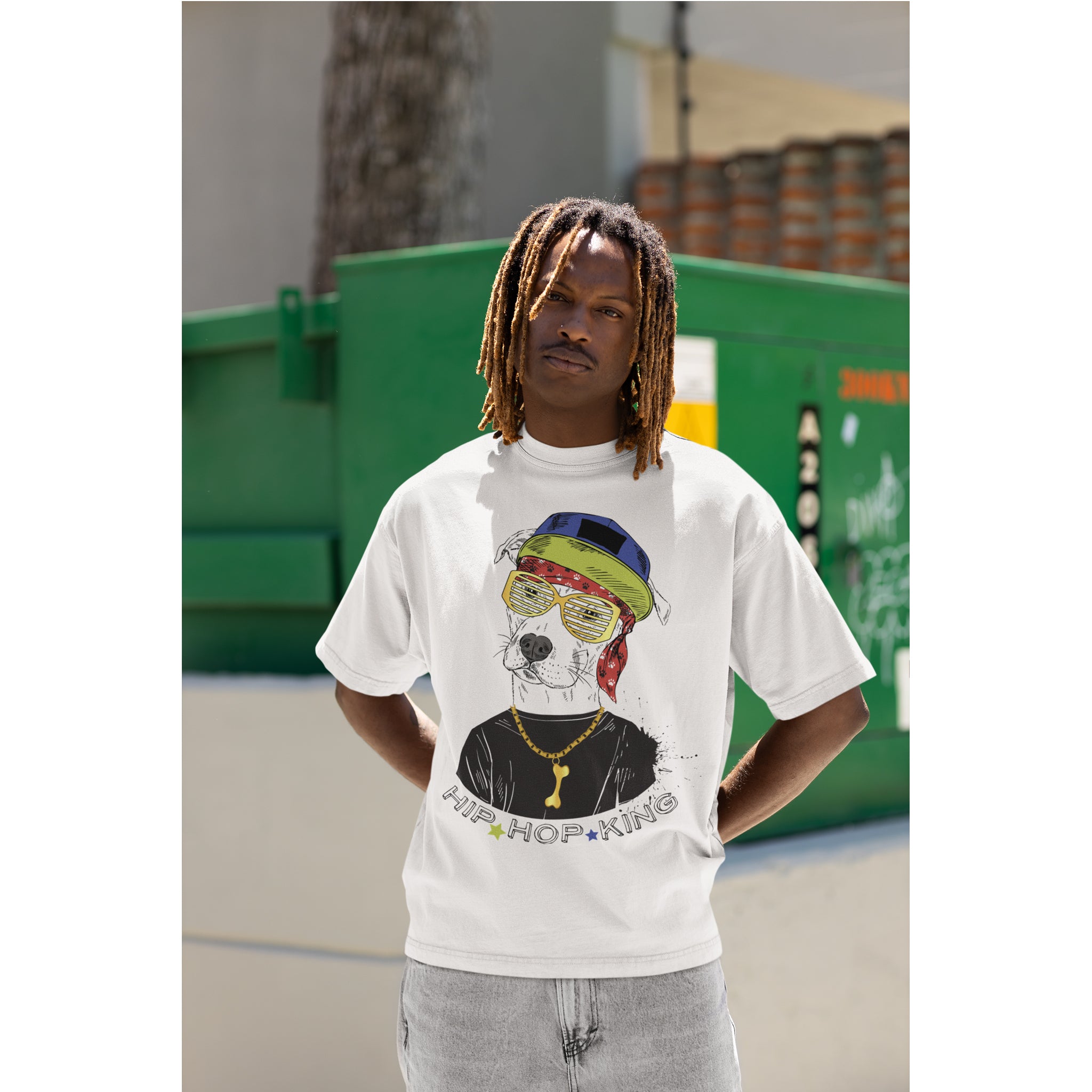 Person wearing a white t-shirt with a graphic design of a dog wearing sunglasses and a hat, with text below.