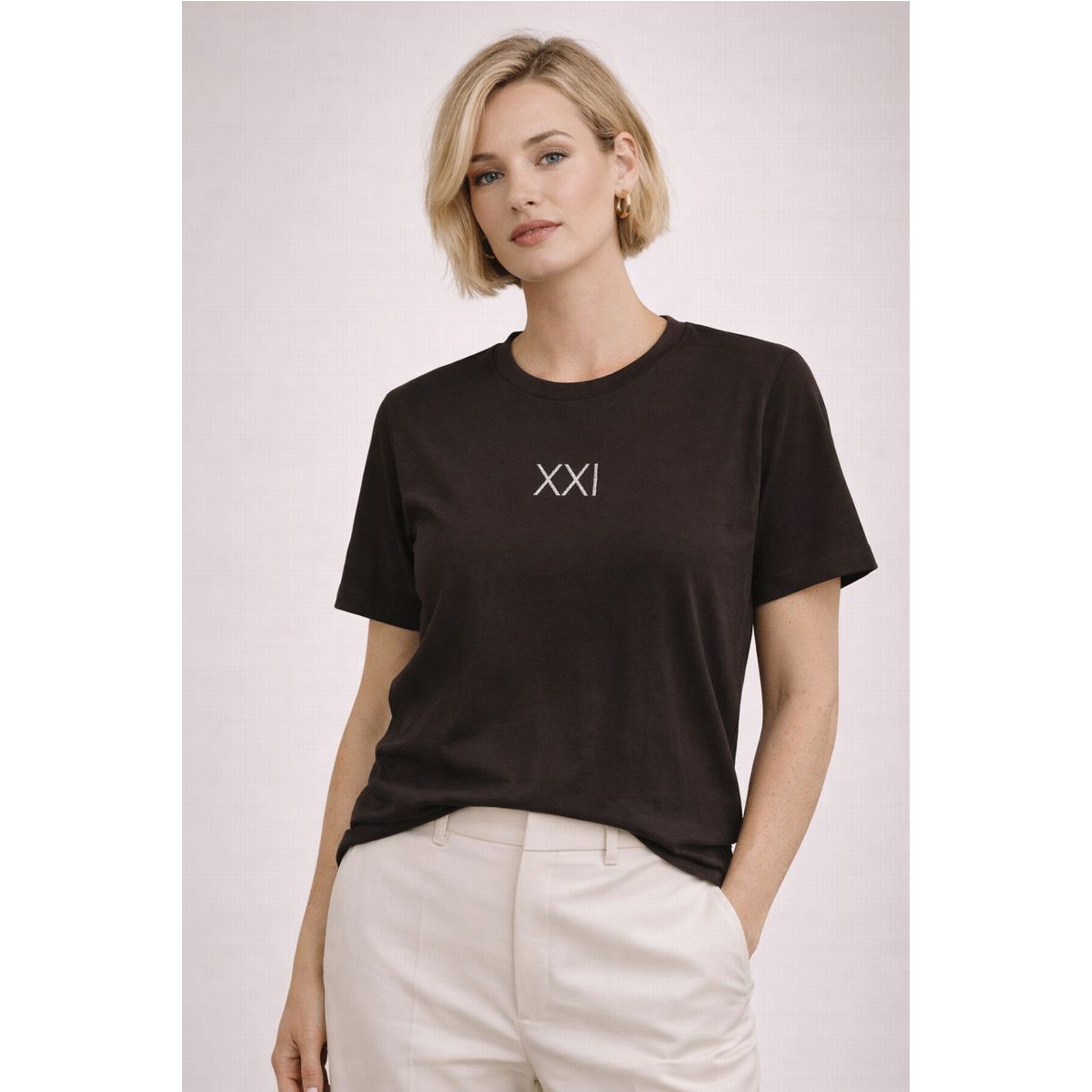 Woman wearing a black t-shirt with 'XXI' logo on a light gray background