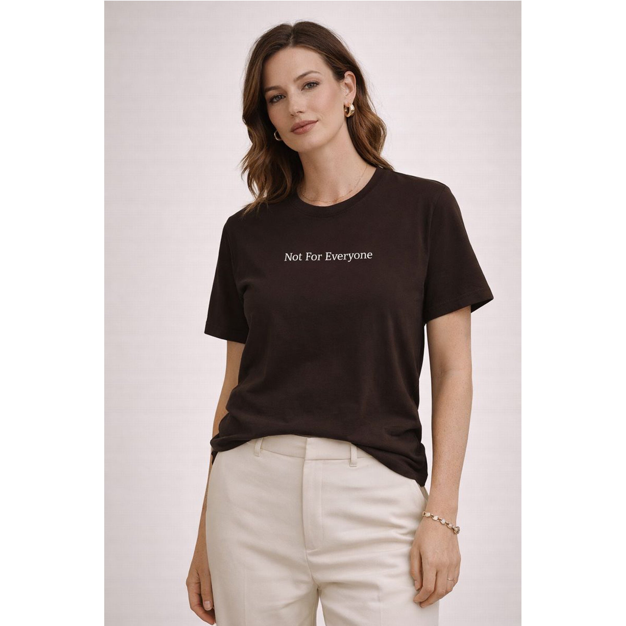 Woman wearing a black t-shirt with 'Not For Everyone' text on a plain background