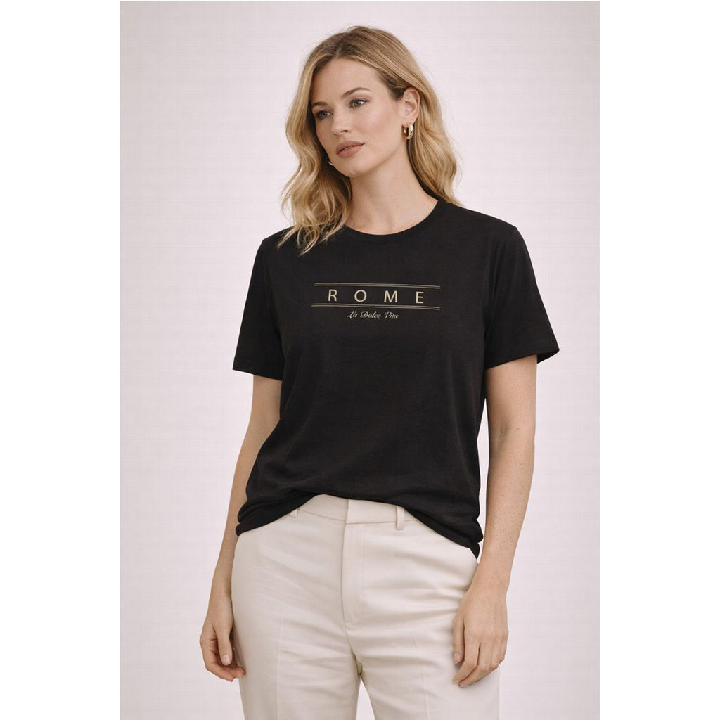 Woman wearing a black t-shirt with 'ROME' text on a light background