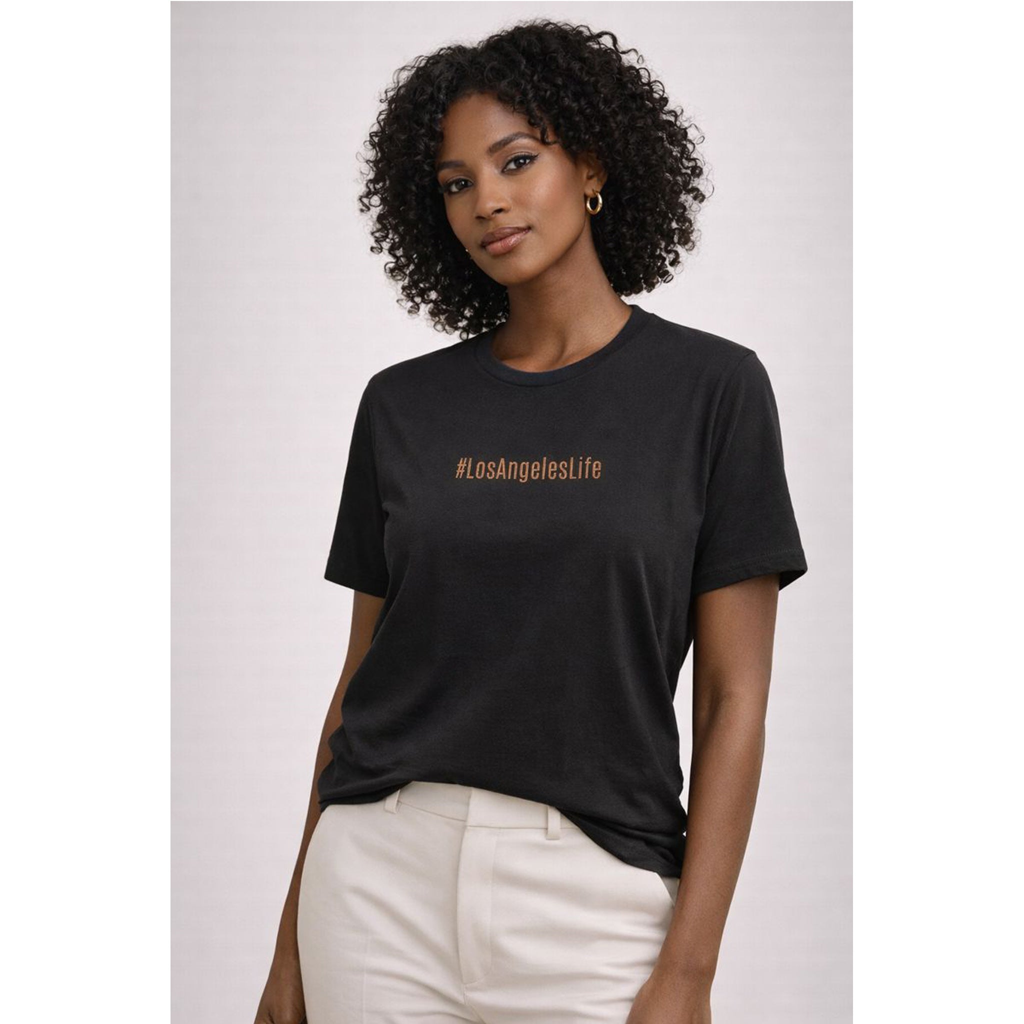 Woman wearing a black t-shirt with '#LosAngeleslife' text on a plain background – Bamerix