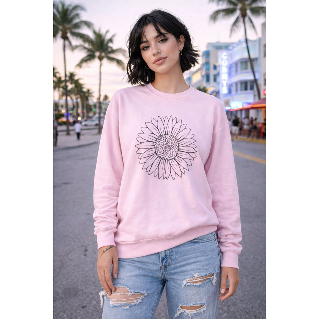 Person wearing a pink sweatshirt with a sunflower design on a city street – Bamerix