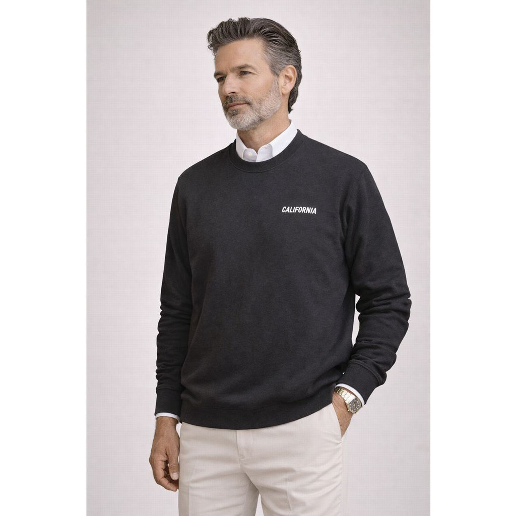 Man wearing a black sweater with 'California' text on a light gray background