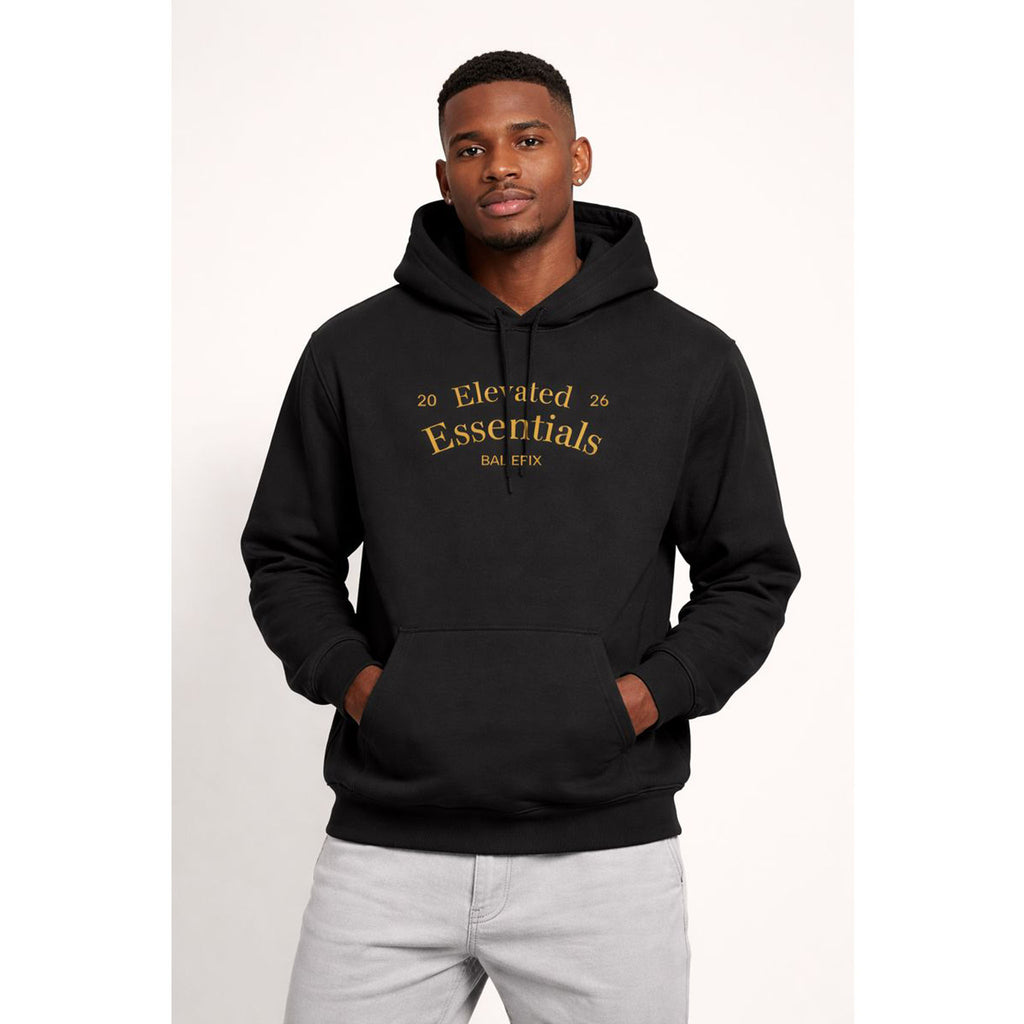 Man wearing a black hoodie with gold text on a white background