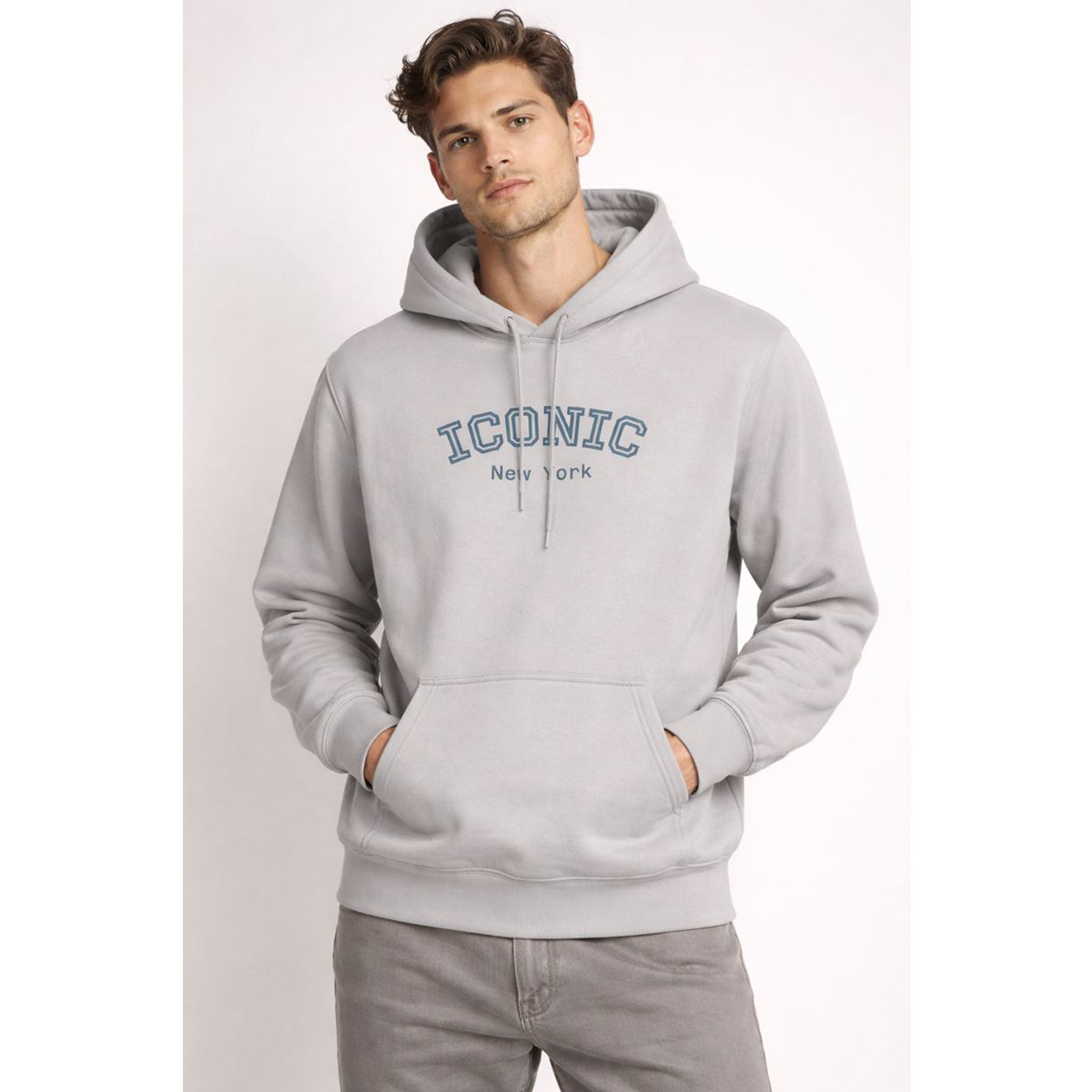Man wearing a gray hoodie with 'Iconic New York' text on a light gray background