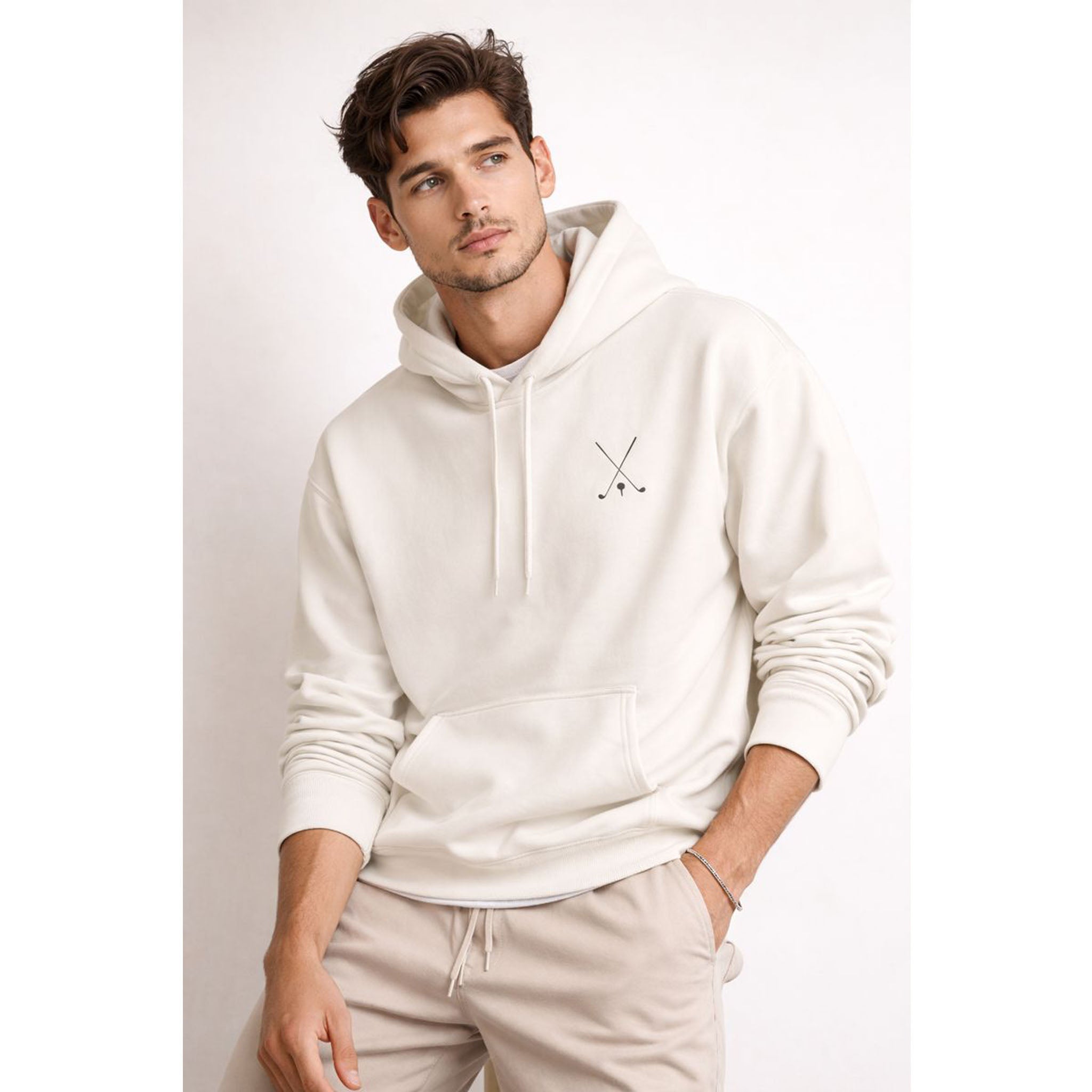 Man wearing a white hoodie with a logo on a plain background