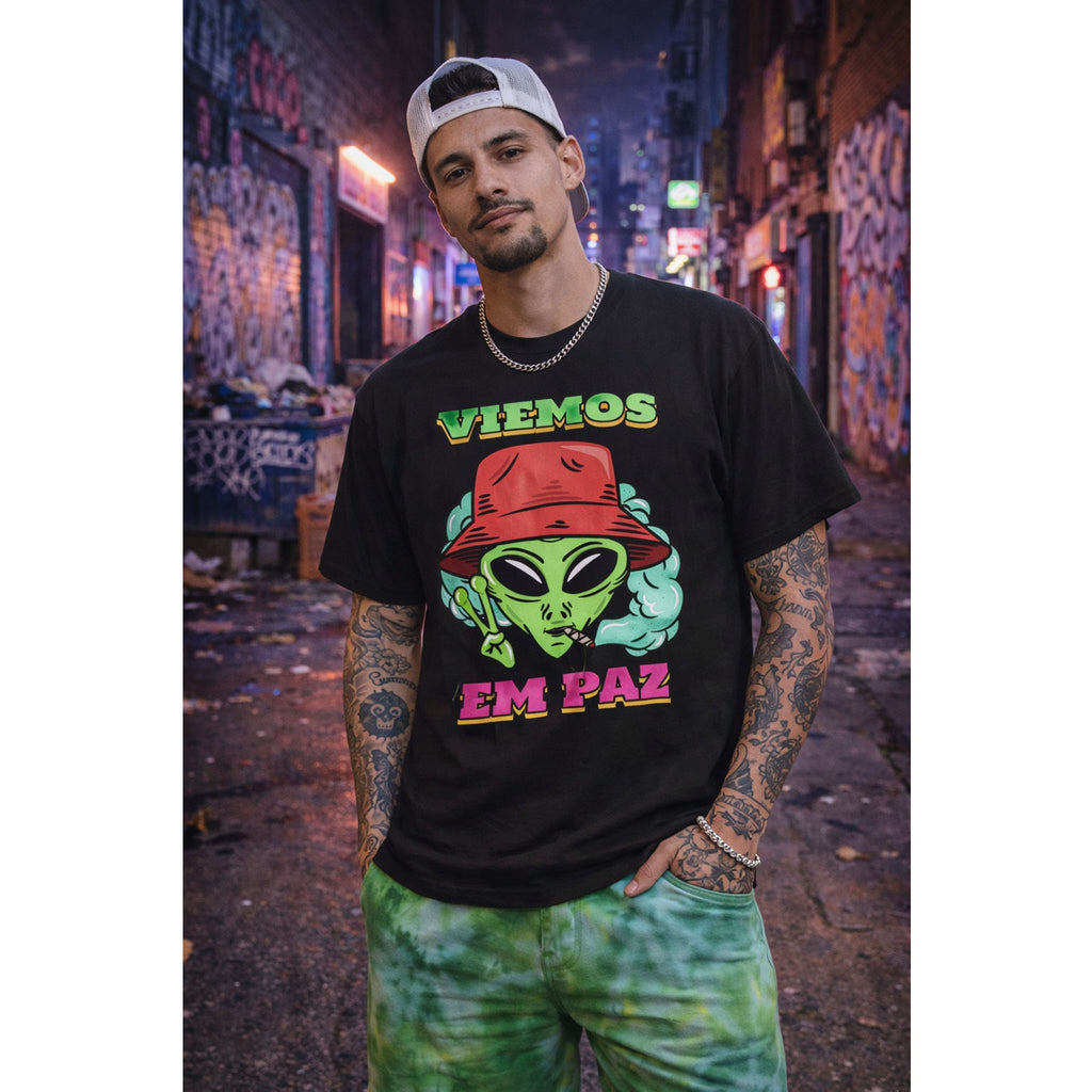 Person wearing a black t-shirt with an alien graphic and text, standing in an urban alleyway – Bamerix