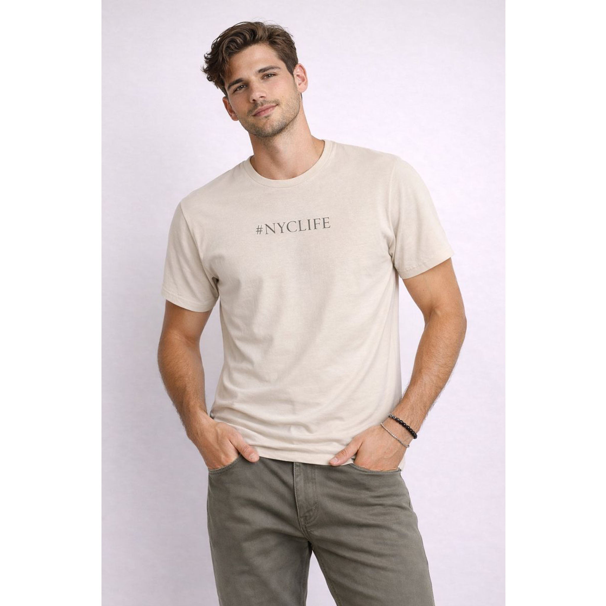 Man wearing a beige '#NYCLIFE' t-shirt against a white background