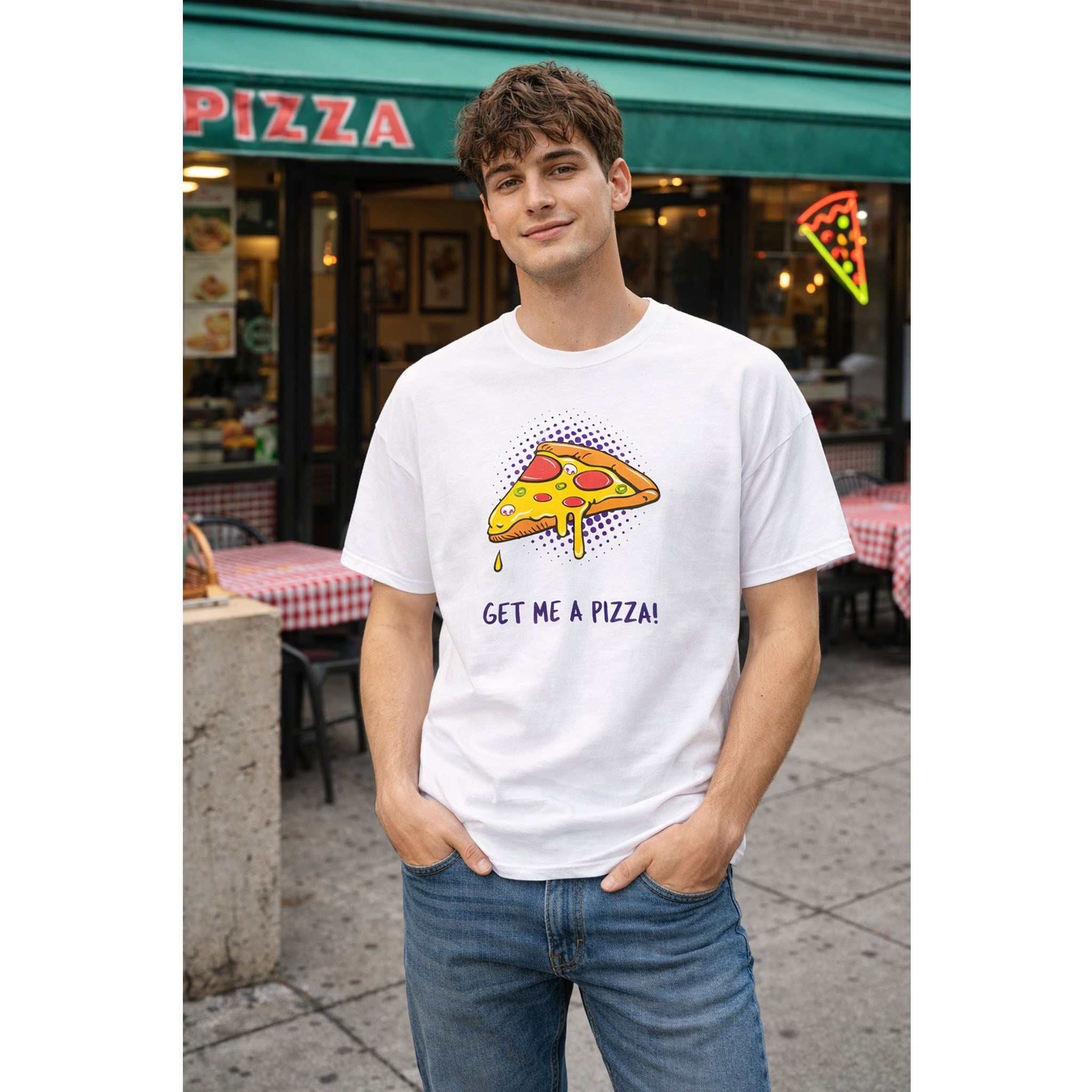 Person wearing a white t-shirt with a pizza graphic and text, standing in front of a pizza restaurant.