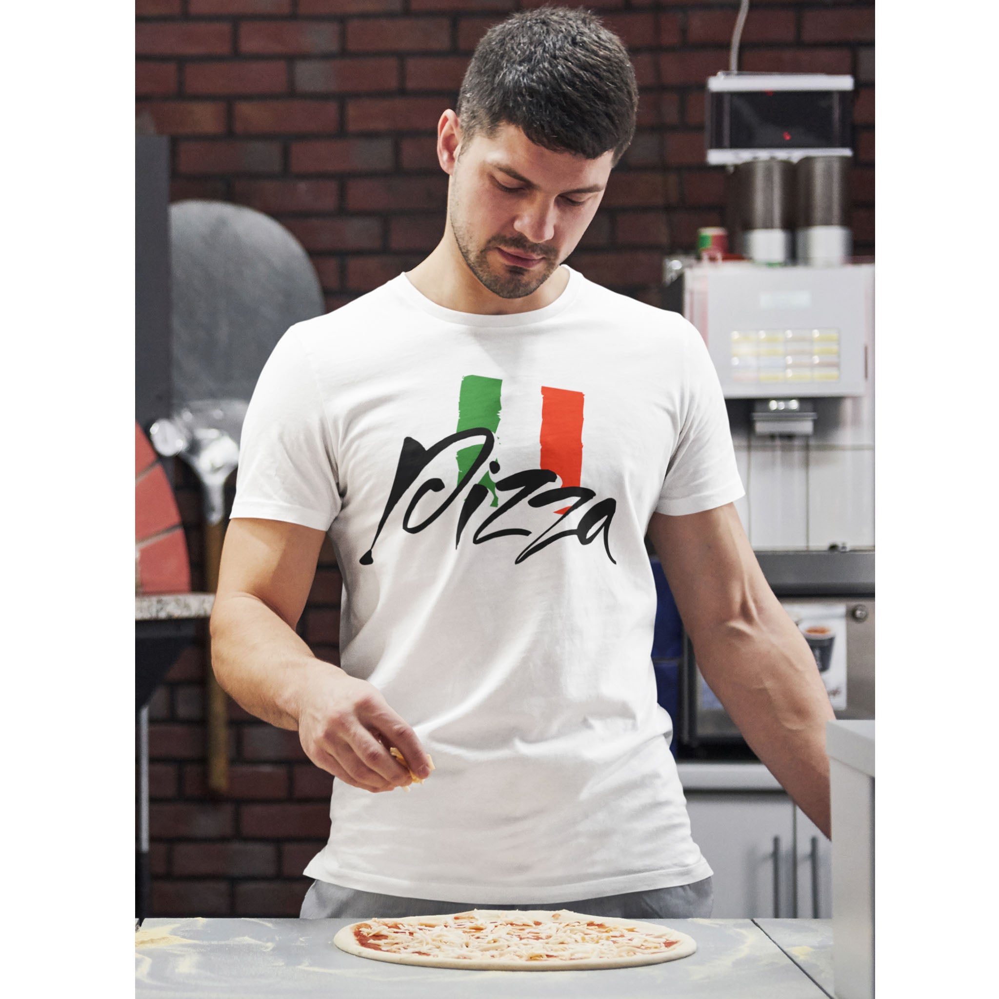 Man in a kitchen wearing a white t-shirt with 'I love pizza' design, preparing a pizza – Bamerix