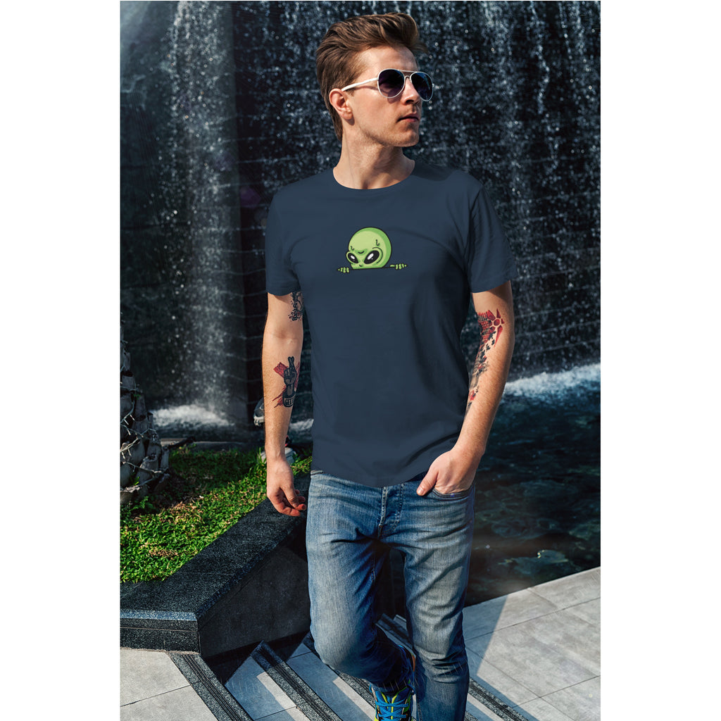Person wearing a navy blue t-shirt with a green alien graphic in front of a waterfall.