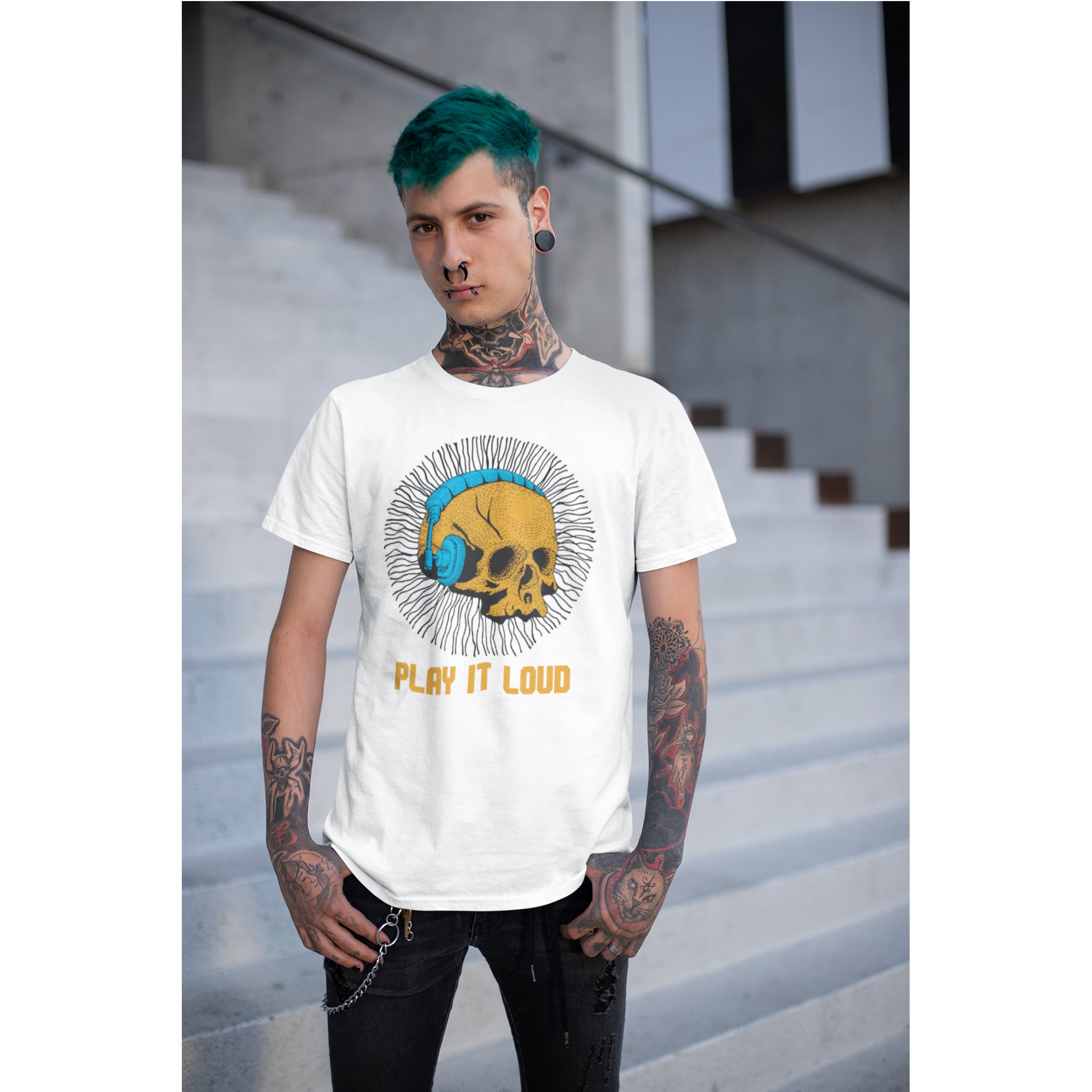 Person wearing a white t-shirt with a graphic design and text, standing on a staircase.