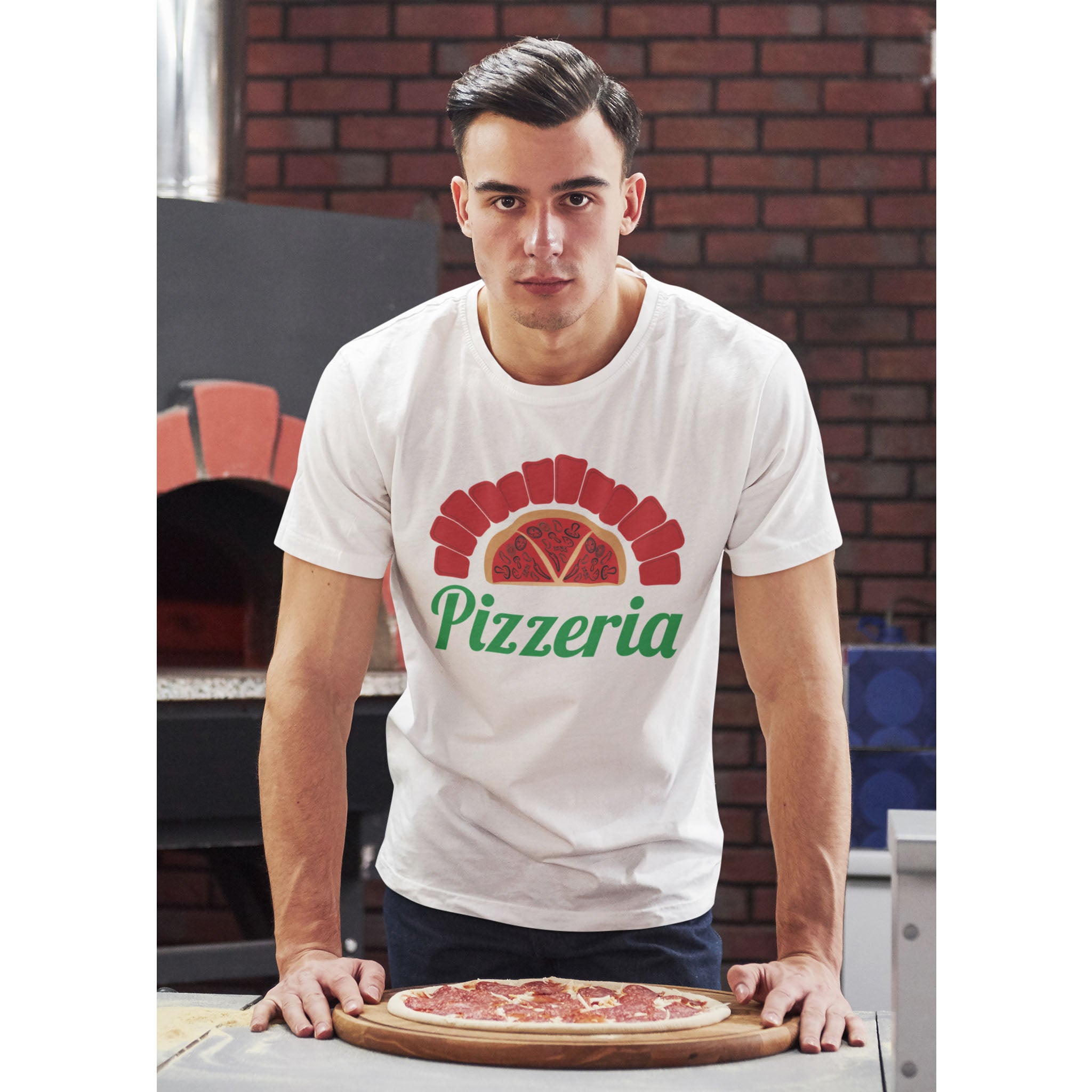 Man wearing a 'Pizzeria' t-shirt holding a pizza in front of a brick wall – Bamerix
