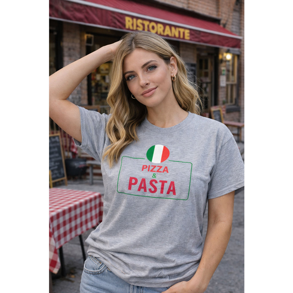 Woman wearing a gray t-shirt with 'Pizza & Pasta' text and Italian flag design, standing in front of a Ristorante.