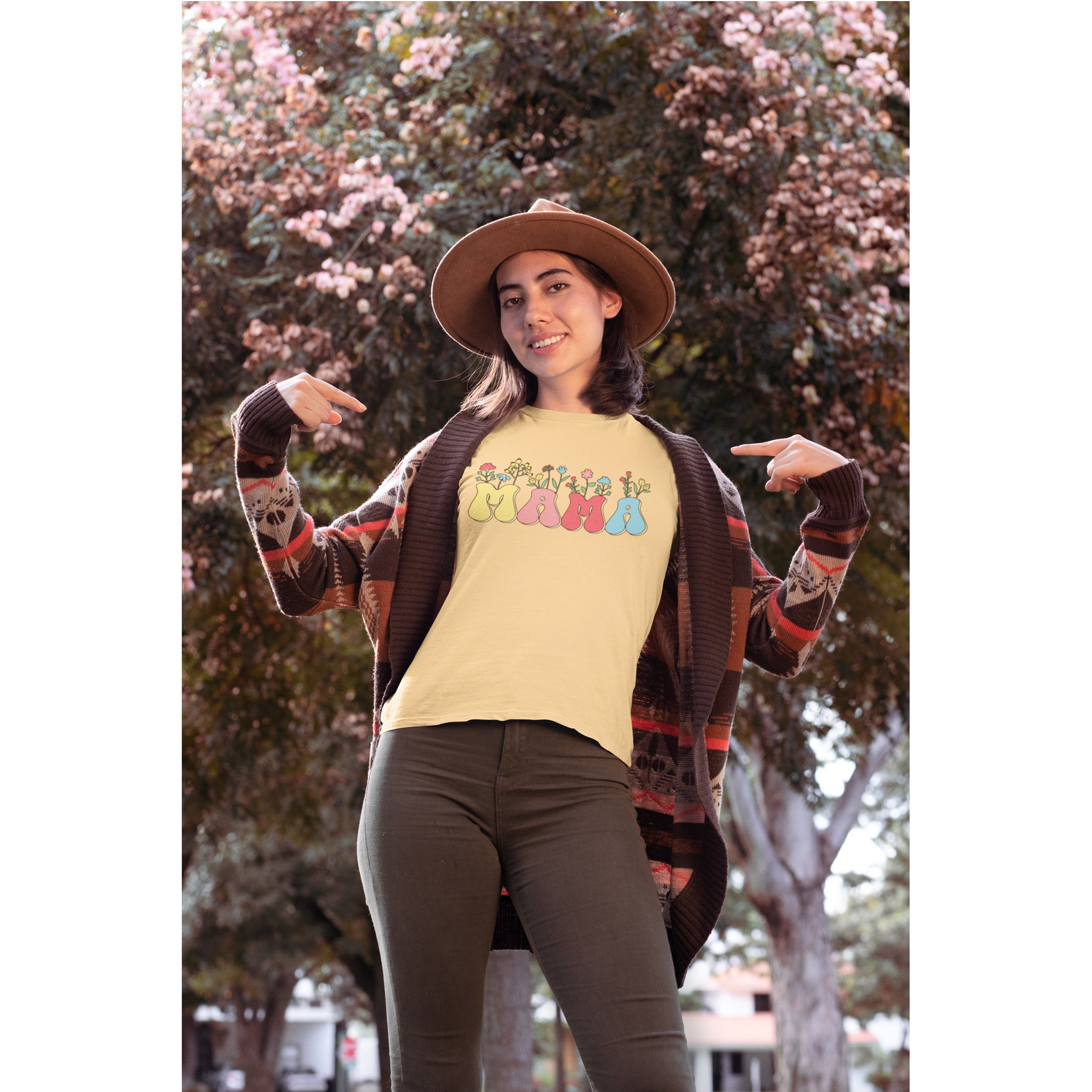 Woman wearing a colorful 'Happy Mama' t-shirt outdoors with trees in the background