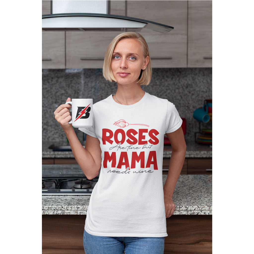Woman in a kitchen wearing a white t-shirt with a humorous print, holding a mug.