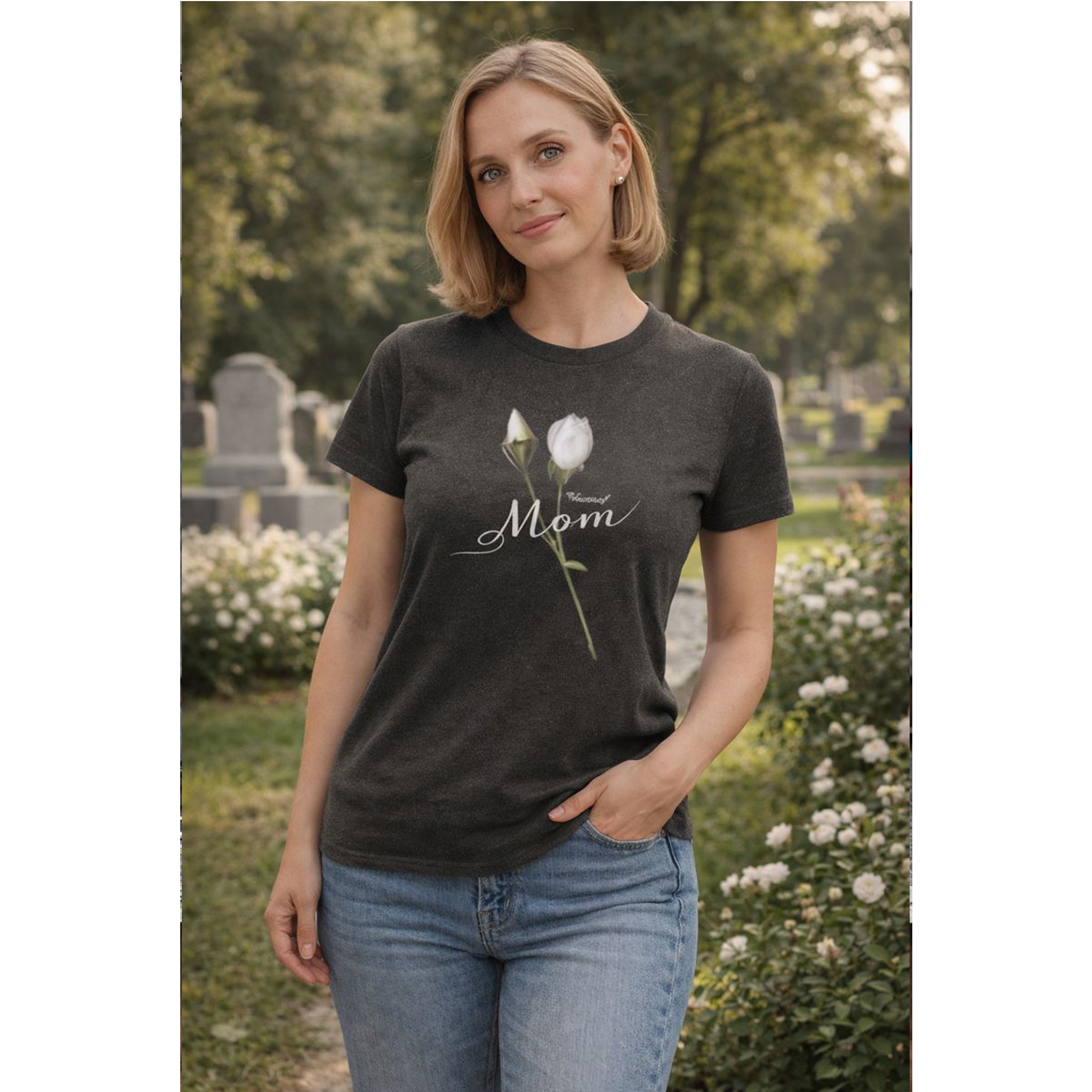 Woman wearing a dark t-shirt with a floral design and 'Mom' text in a garden setting