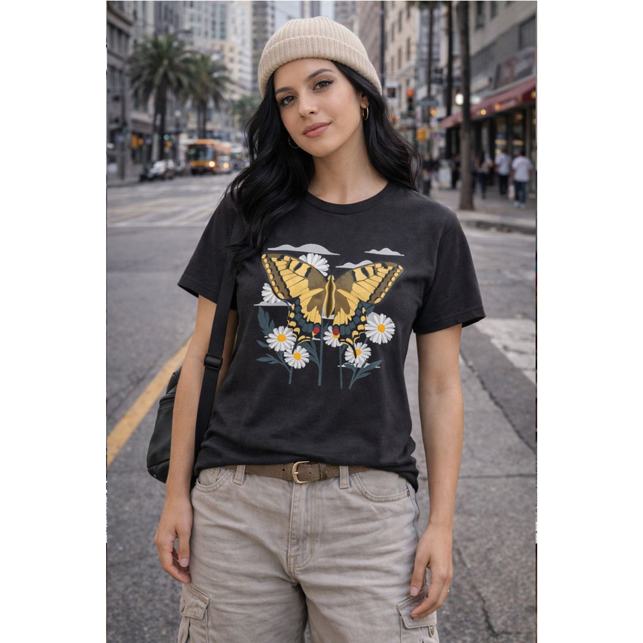 Woman wearing a black t-shirt with a butterfly design on a city street – Bamerix
