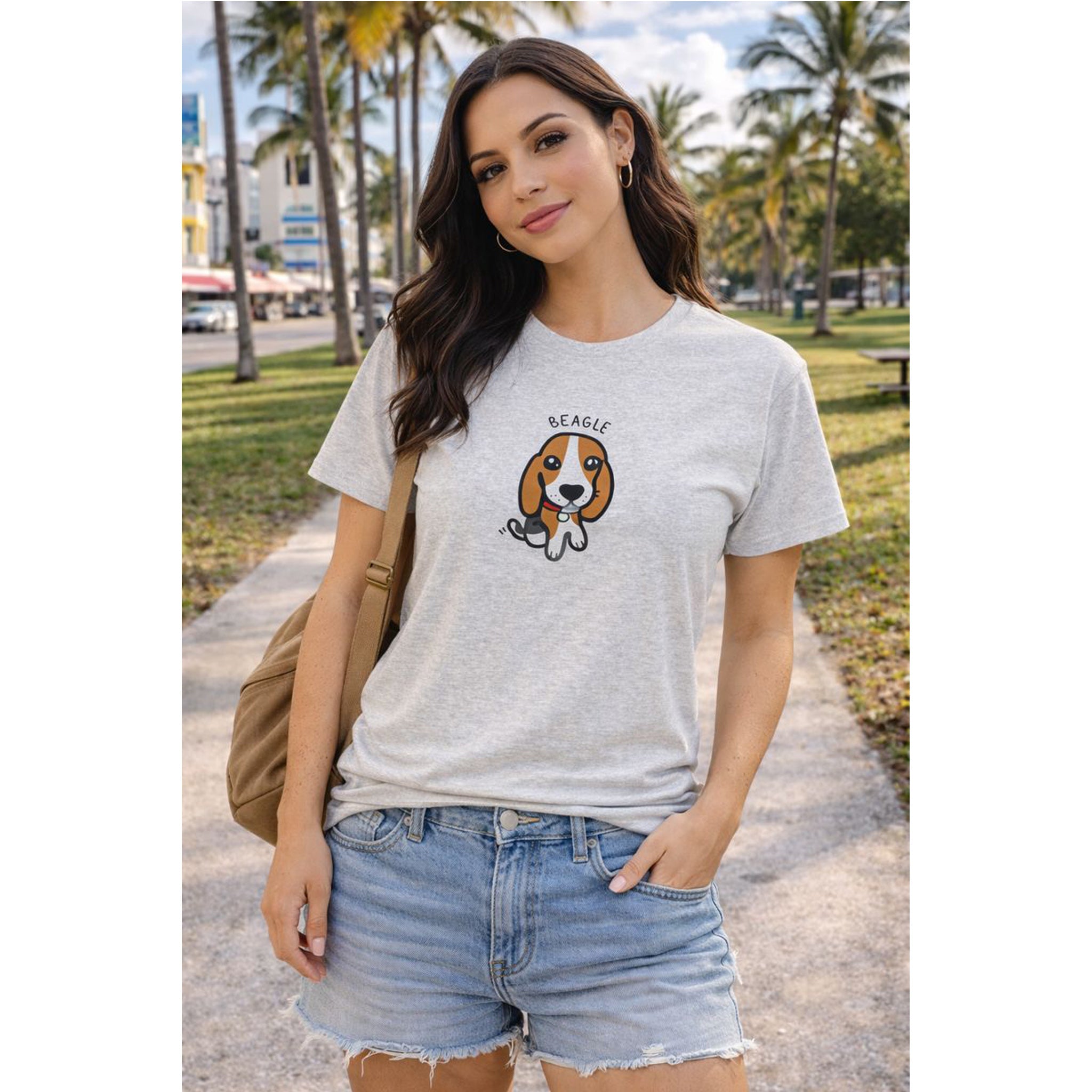 Woman wearing a gray t-shirt with a beagle graphic in an outdoor setting with palm trees.
