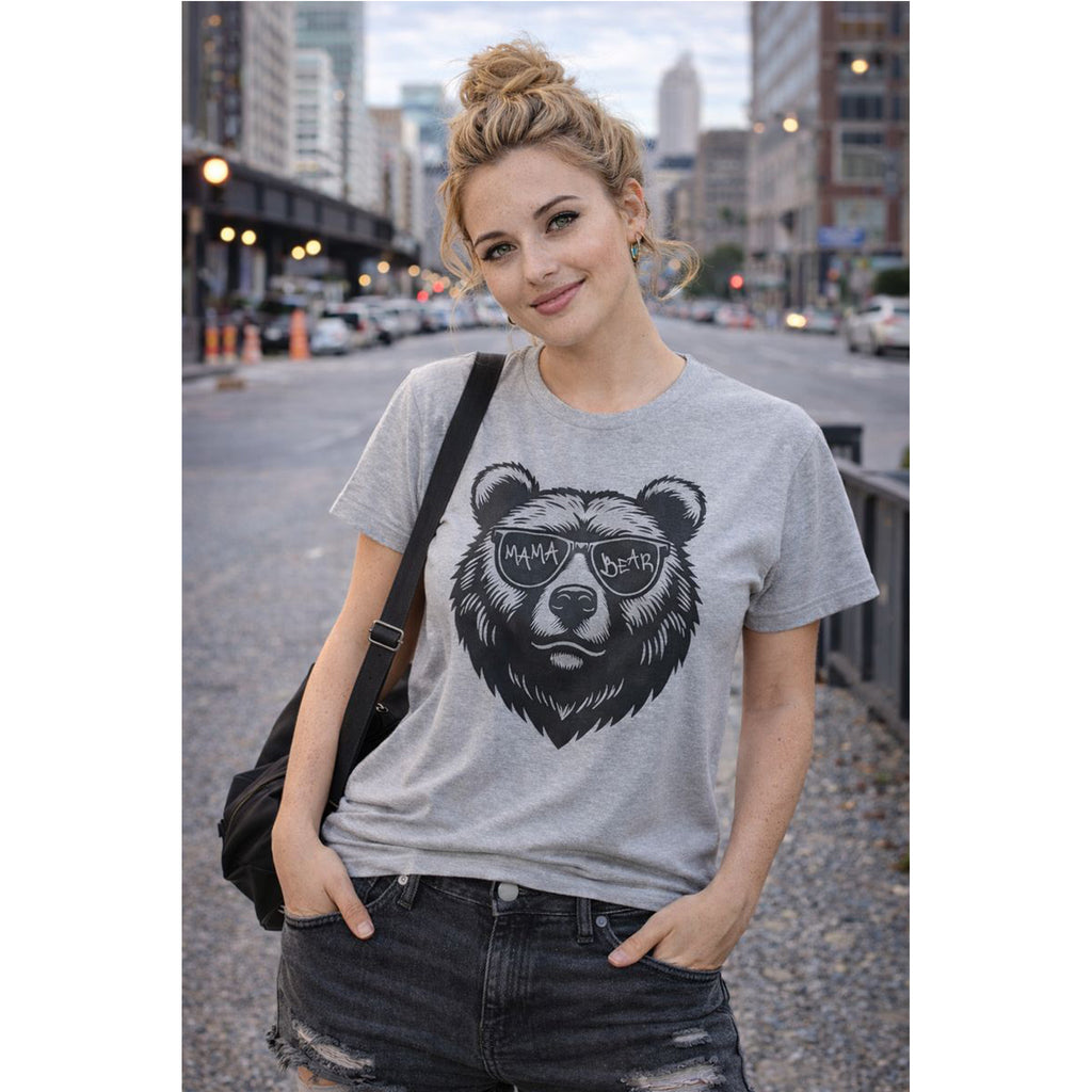 Woman wearing a gray t-shirt with a bear graphic in an urban setting