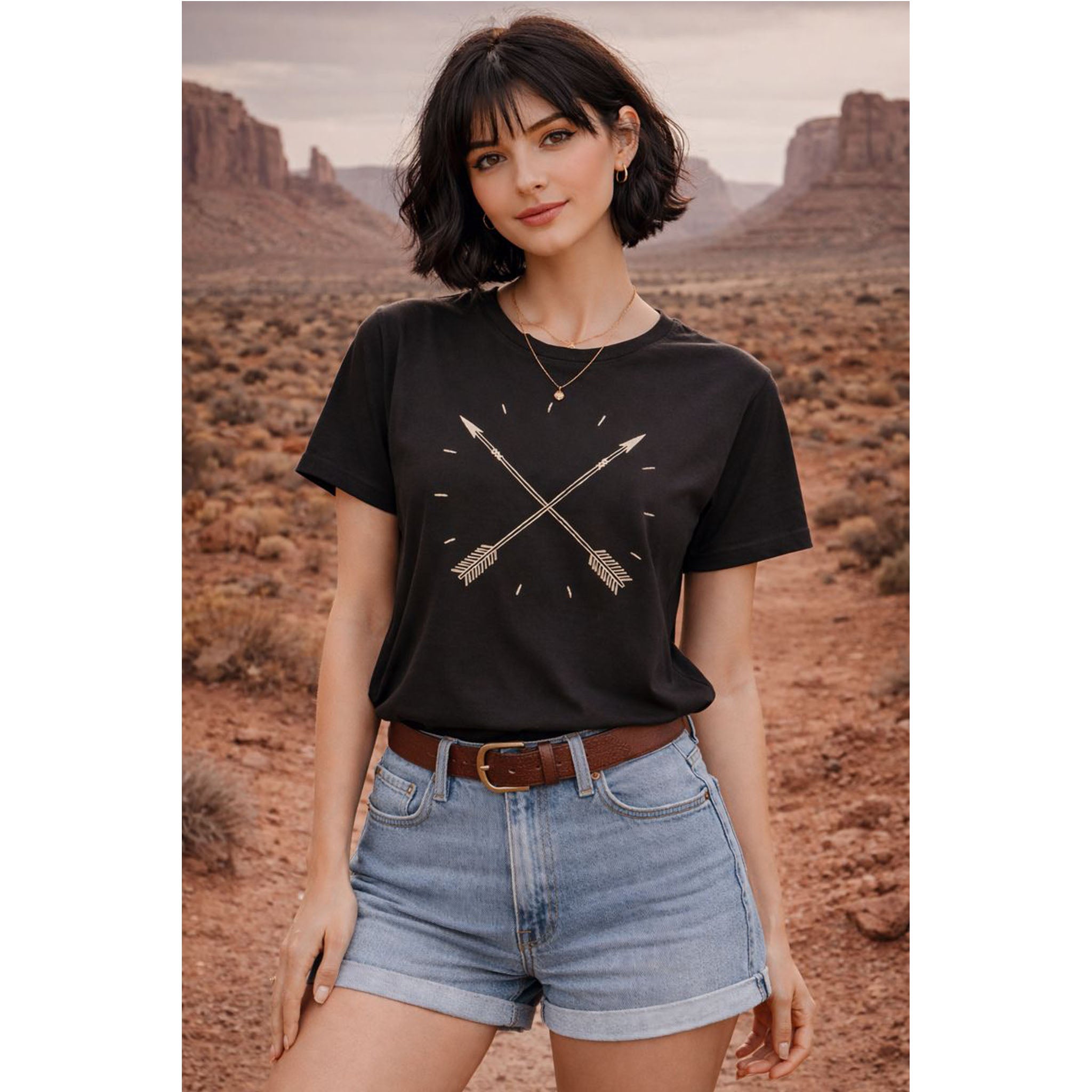 Woman wearing a black t-shirt with a graphic design in a desert setting