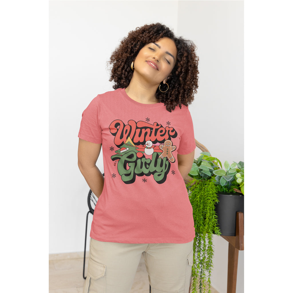 Woman wearing a pink t-shirt with 'Winter Girl' text, standing indoors.