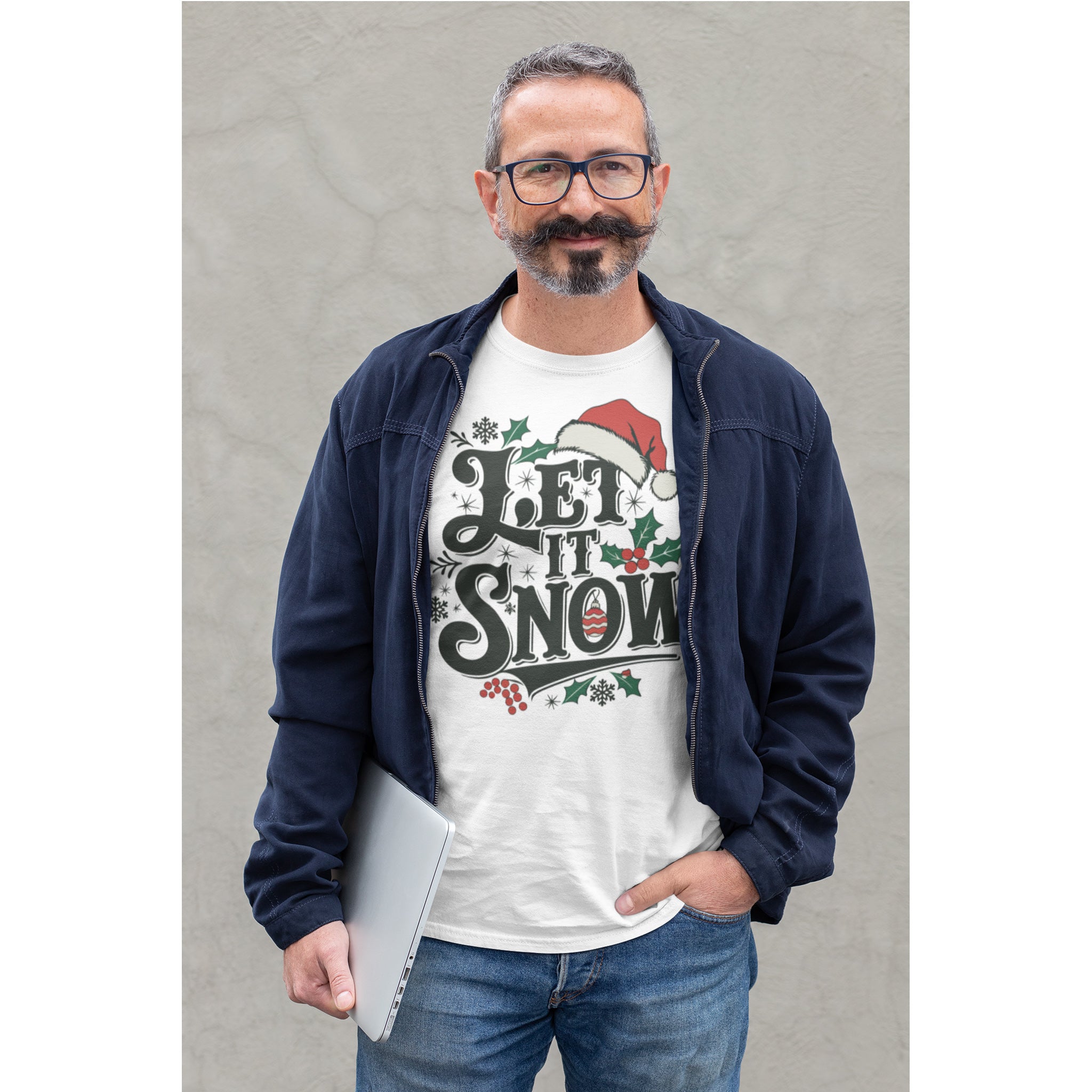 Man wearing a 'Let It Snow' Christmas t-shirt against a gray background