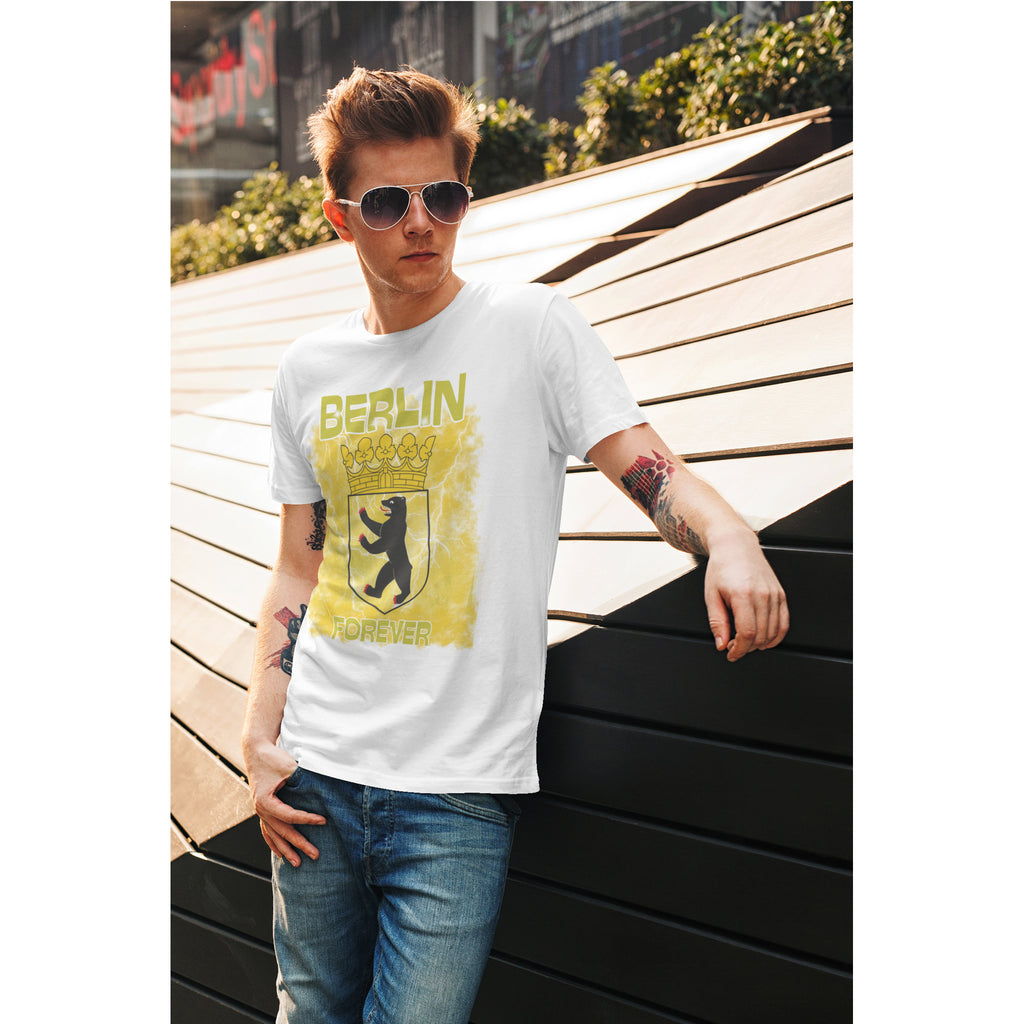 Man wearing a white t-shirt with a yellow graphic design, standing outdoors.