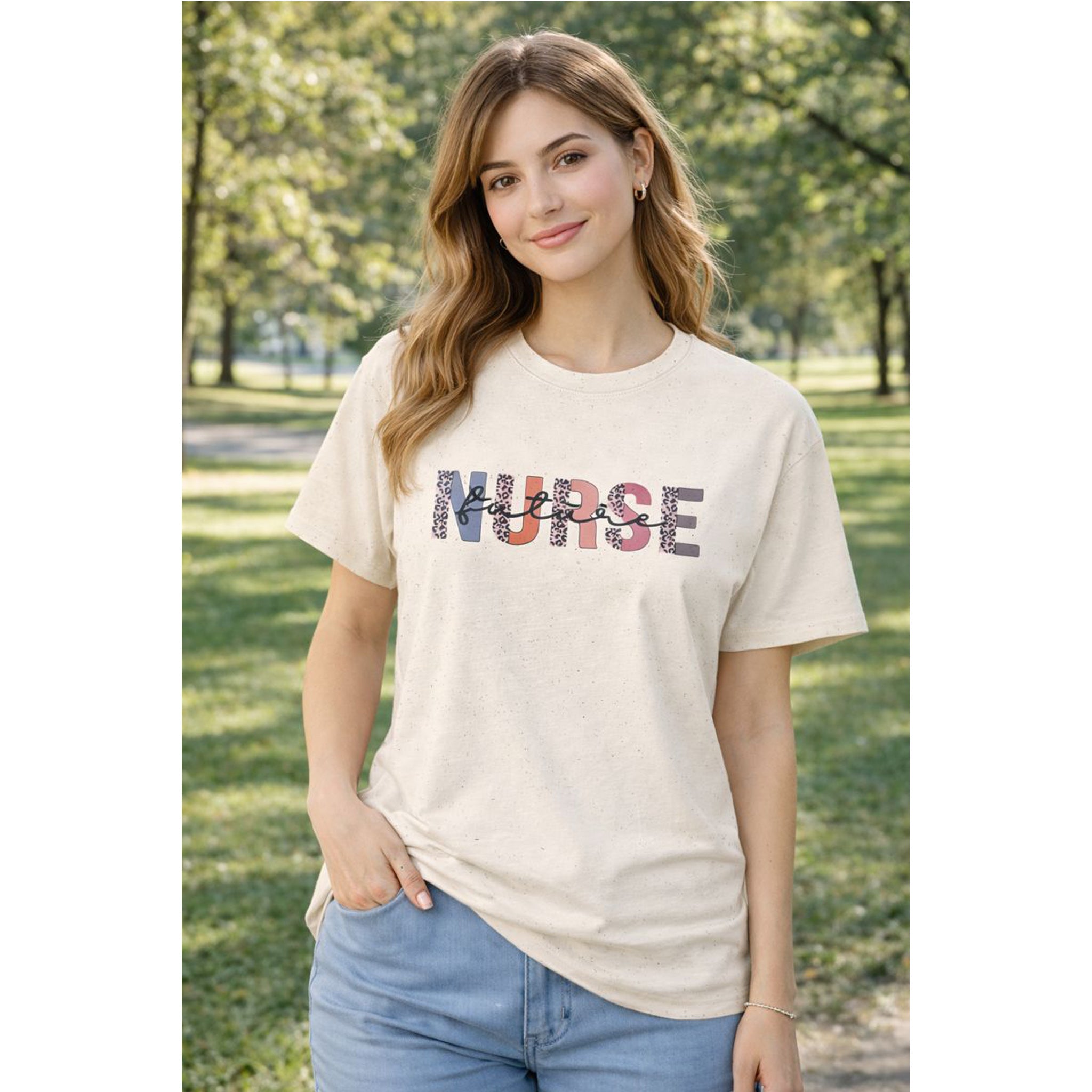 Woman wearing a 'NURSE' t-shirt outdoors in a park