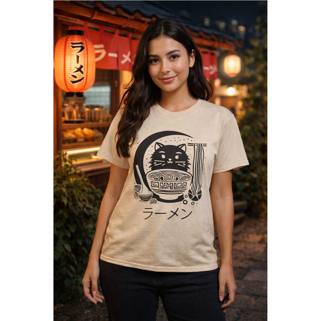 Woman wearing a beige t-shirt with a black graphic design in an outdoor setting with lanterns.